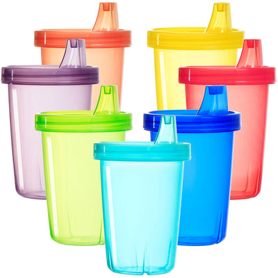 Set of colorful sippy cups with lids on a white background