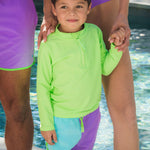 RUGGEDBUTTS Boys UPF50+ Sun Protected Stretch Dolphin Hem Swim Trunks - Neon Bright Aqua Color Block, 3-6m