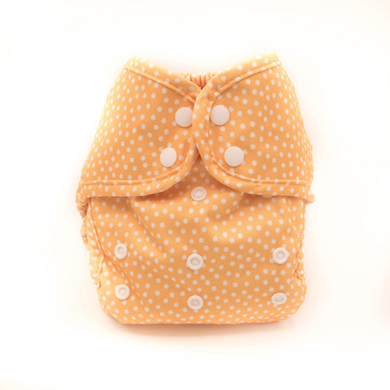 Yellow diaper with white polka dots on a white background