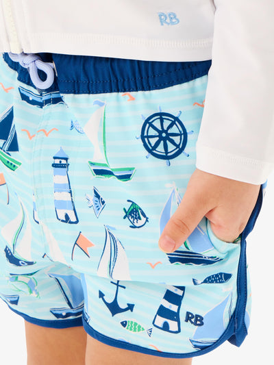 RUGGEDBUTTS Boys UPF50+ Sun Protected Stretch Dolphin Hem Swim Trunks - Blue Sweet Sails, 0-3m