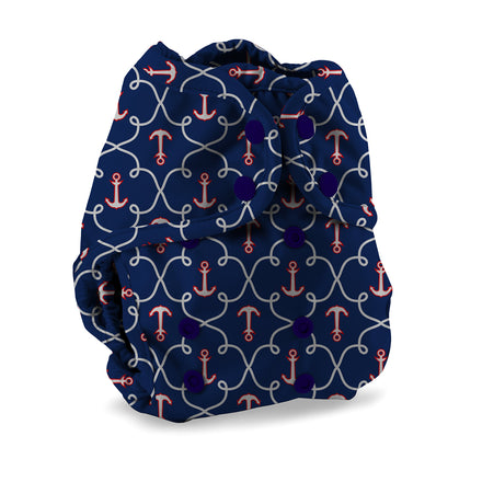 Navy blue diaper cover with pink anchors and white patterns on a white background
