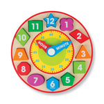 Colorful wooden clock toy with numbered and shaped pieces on a white background