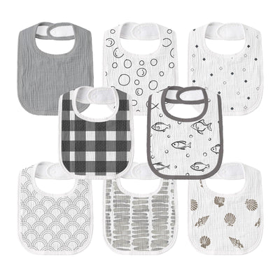 Set of eight baby bibs with various patterns on a white background