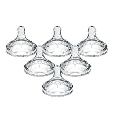 Set of five clear baby bottle nipples on a white background