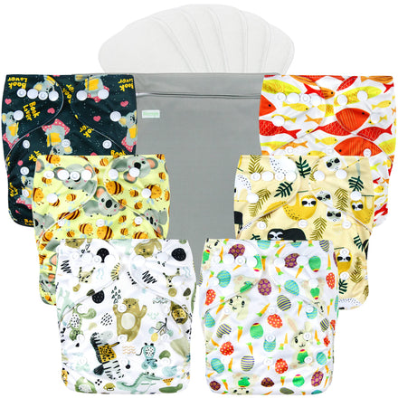 Set of colorful patterned cloth diapers with a gray changing pad on a white background