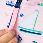 RuffleButts Girls UPF50+ Sun Protection Front Zipper Long Sleeve Rash Guard One Piece Swimsuit - Pink Sweet Sails, 2T