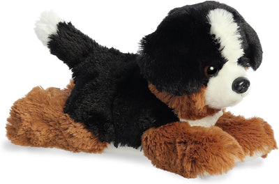 Plush toy dog with black, brown, and white fur on a white background