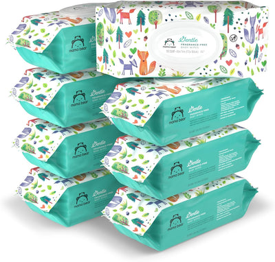 Stack of baby wipes packages with colorful designs on a white background