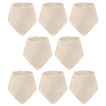 Set of eight beige baby bibs on a white background