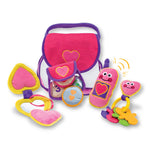 Colorful toy set with a pink bag, plush toys, and rattles on a white background