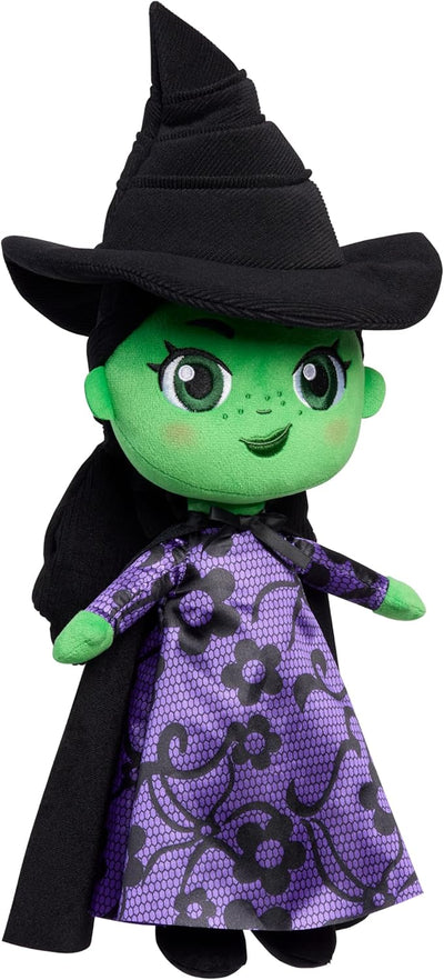 Toy figure of a witch with green face, black hat, and purple dress with black patterns on a white background