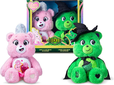 Two plush toys, a pink and a green bear, with a Care Bears box in the background.