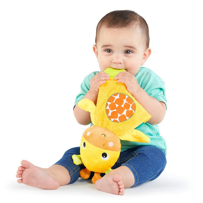 Baby holding a yellow plush toy with a white background