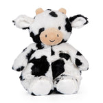 Plush cow toy with black and white pattern on a white background