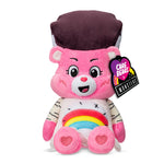 Pink plush toy with a rainbow design and heart shapes, featuring a Care Bears tag.