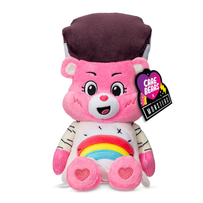 Pink plush toy with a rainbow design and heart shapes, featuring a Care Bears tag.