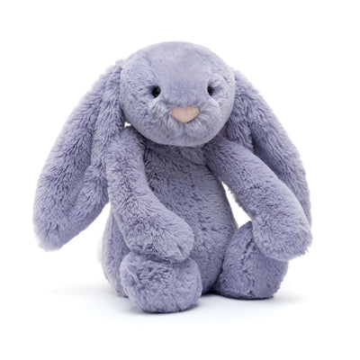 Plush toy rabbit in a sitting position on a white background