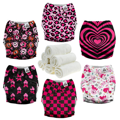 Collection of patterned cloth diapers and white washcloths on a white background