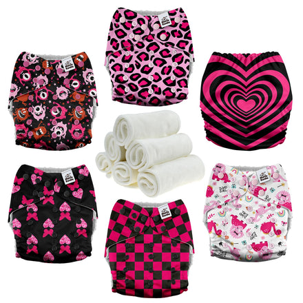 Collection of patterned cloth diapers and white washcloths on a white background