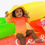 RuffleButts Baby Girls UPF 50+ Sun Protection Novelty Print Long Sleeve One Piece Rash Guard Swimsuit with Zipper - Neon Citrus Sunrise, 2T