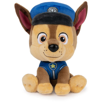 Plush toy dog in a police uniform on a white background
