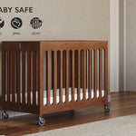 Foundations Boutique Folding Mini Baby Crib, Compact, Portable, Wooden Hotel Crib, Foldable Mini Crib for Baby & Toddlers, Includes 3" Foam Mattress, Cherry