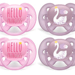 Two pink 'Hello Princess' pacifiers and two purple swan pacifiers on a white background