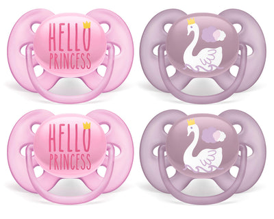 Two pink 'Hello Princess' pacifiers and two purple swan pacifiers on a white background