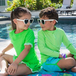 RUGGEDBUTTS Boys UPF50+ Sun Protected Stretch Dolphin Hem Swim Trunks - Neon Bright Aqua Color Block, 3-6m