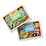 Two wooden magnetic sets, one with dinosaur shapes and the other with animal shapes, in wooden boxes on a white background.