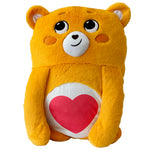 Yellow plush bear with a red heart on a white background