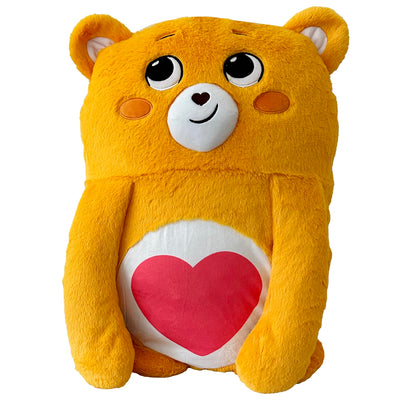 Yellow plush bear with a red heart on a white background