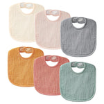 Set of six colorful baby bibs on a white background