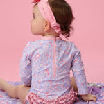 RuffleButts Baby Girls UPF 50+ Sun Protection Floral Printed Long Sleeve One Piece Rash Guard Swimsuit with Zipper - Lavender Floral Princess, 3-6 Months