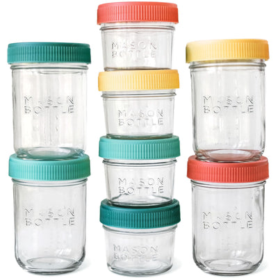 Set of clear mason jars with colorful lids on a white background