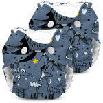 Two baby diapers with a night-themed design featuring stars, moons, and trees on a white background.