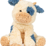 Plush toy cow with blue accents on a white background