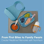 Mealtime setup with NumNum products including a tray, bowl, and sippy cup on a blue background.