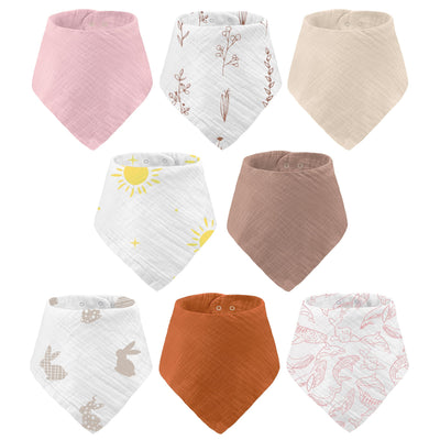 Collection of colorful baby bibs with various patterns on a white background