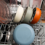 Dishwasher with a blue lid on a silver rack