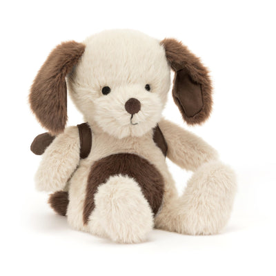 Stuffed dog toy with brown spots on a white background