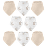 Set of baby bibs with beige and white patterns on a white background