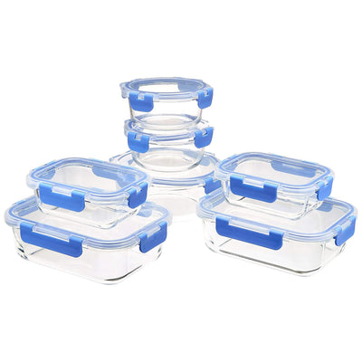 Set of clear glass food storage containers with blue lids on a white background