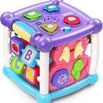 Colorful children's toy cube with various educational elements on a white background