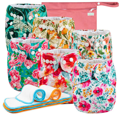Set of colorful floral-patterned cloth diapers with a pink pouch in the background.