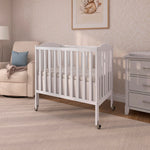 Dream On Me 2-in-1 Folding Portable Compact Mini Baby Crib in White, GreenGuard Gold & BSA, US Patented Flat Folding System, Locking Wheels,1″ Mattress Pad, Space-Saving Quck Fold Easy Storage